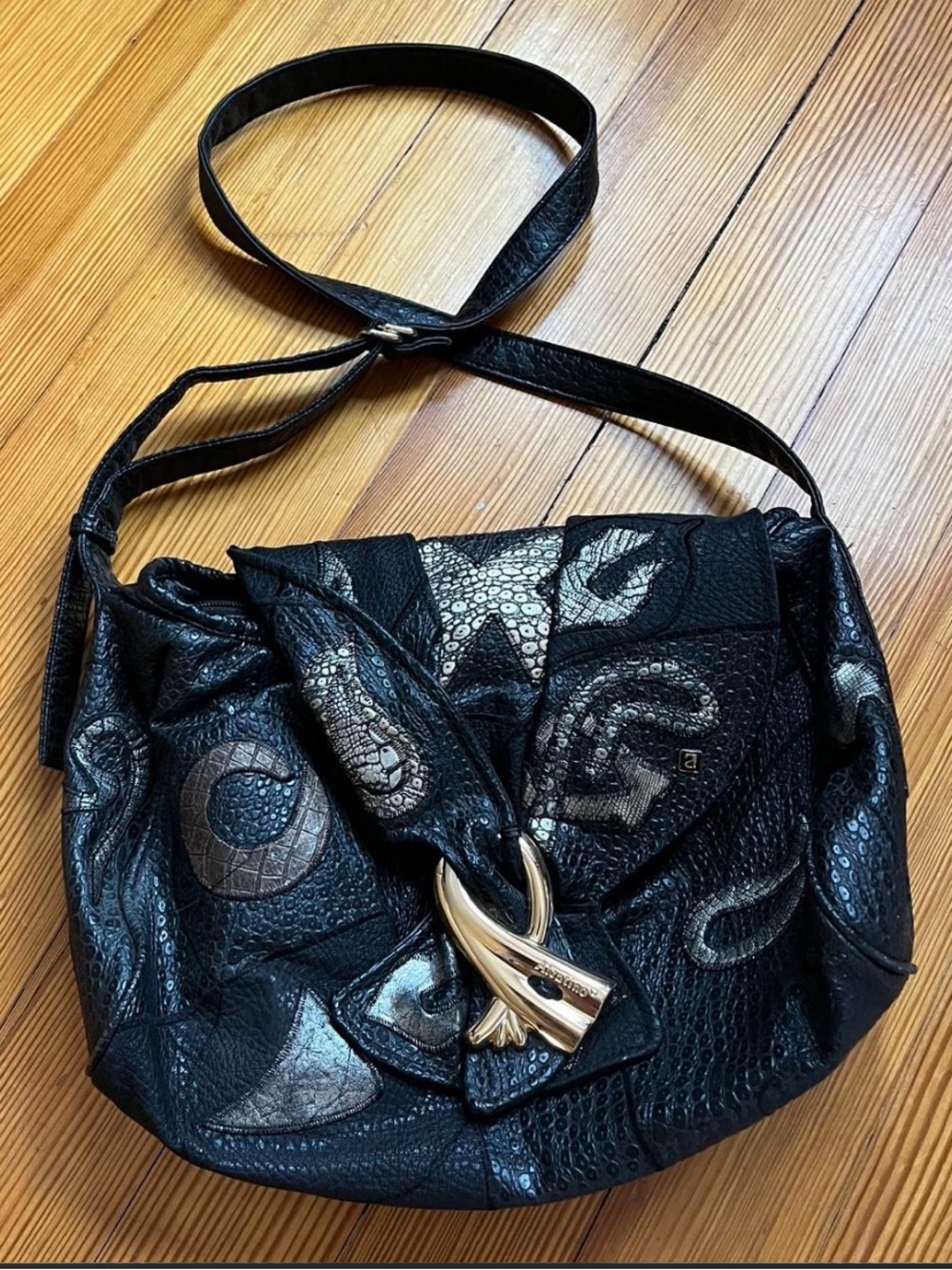 Vintage 80’s NAS bag featuring a faux-gold accent & metallic glam